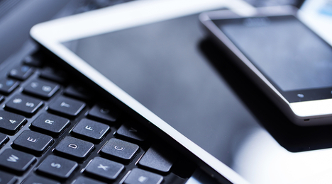 phone and tablet on keyboard