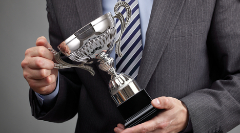 businessman carries award