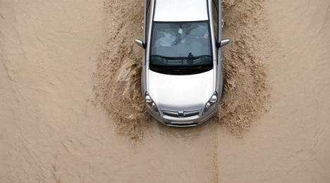 car driving on flooded highway