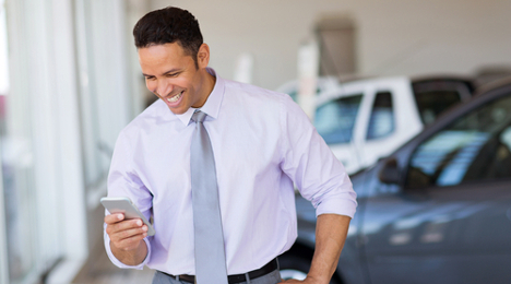 salesman texting in showroom