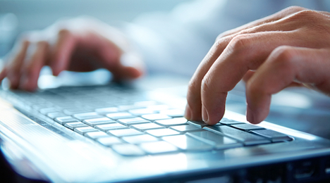 hands typing on keyboard