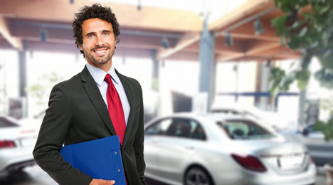 salesman in front of car