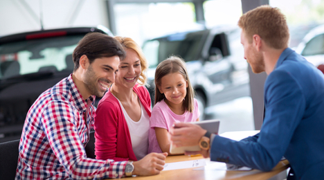 car salesman utilizing technology