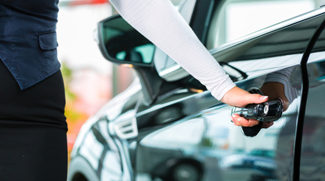 person opening car in showroom