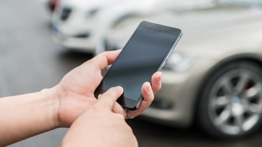 person on phone near cars_5